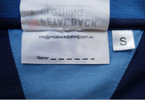 Close-up of a clothing label, showing the space where the owner's name can be written.