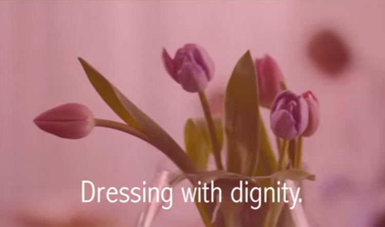 Video of a carer and patient, showing how to dress someone easily using petal back clothing 